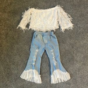 White off shoulder top and bell bottom jeans